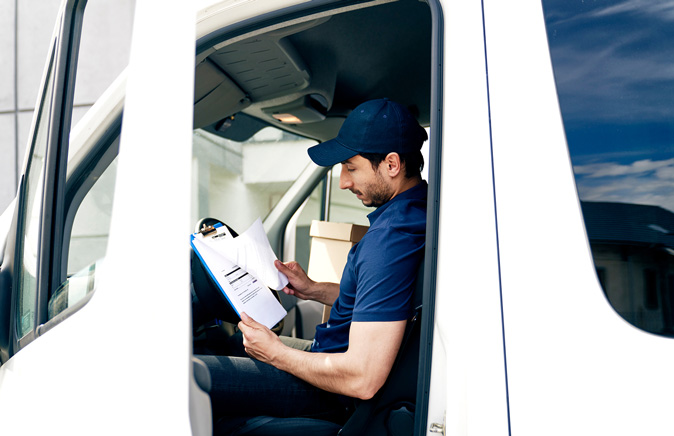 delivery-driver-inside-van-checking-clipboard