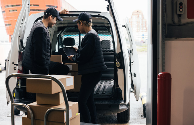 two-couriers-loading-boxes-in-to-van