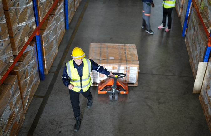 warehouse-worker-pulling-heavy-crate